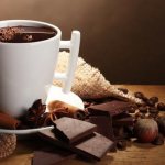 Cup of coffee with chocolate and cinnamon