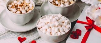 Cup with marshmallows on the table and coffee