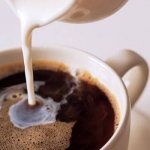 Add milk to a cup of coffee